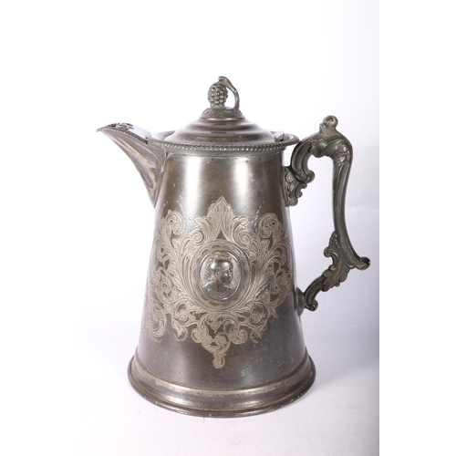 102 - Metal jug with hinge top and classical busts to sides, 30cm high.