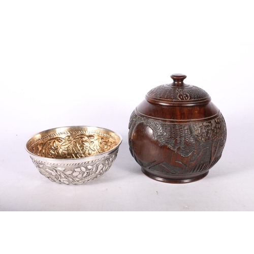 103 - Carved wooden lidded circular box, and a white metal bowl, possibly Indian.