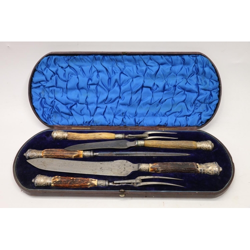 79 - Cased horn handled carving set.