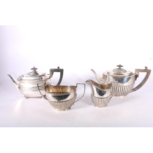 84 - Two EPNS teapots, a milk jug and a sugar bowl.