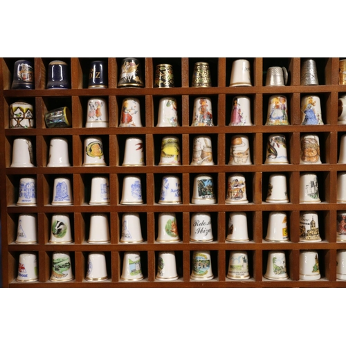 85 - Large collection of porcelain thimbles, with display cabinets.