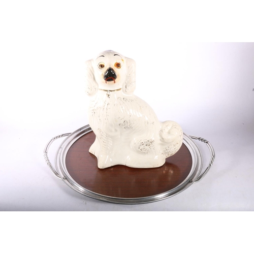 109 - Staffordshire spaniel, 34cm high, with a wood and metal tray.