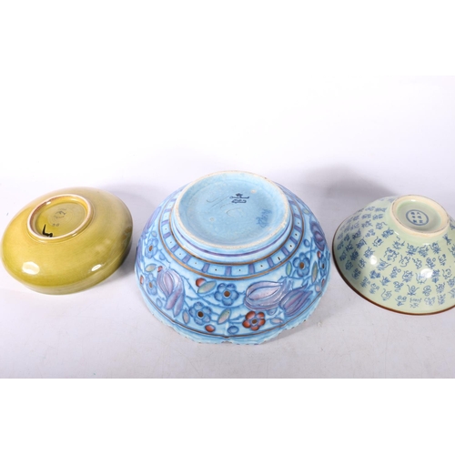 65 - Poole Pottery bowl, 17cm diameter, a Chinese bowl, and a Charlotte Rhead bowl.