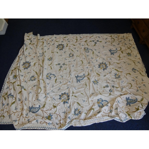 27 - White bedcover with blue embroidered floral ornament, a part patchwork quilt and other textiles.