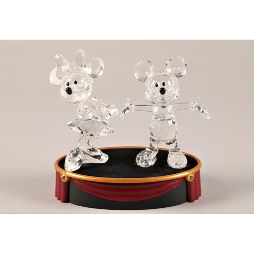 17 - Four pieces of Swarovski crystal, including Mickey Mouse, Minnie Mouse on display base, Goofy and Pl... 