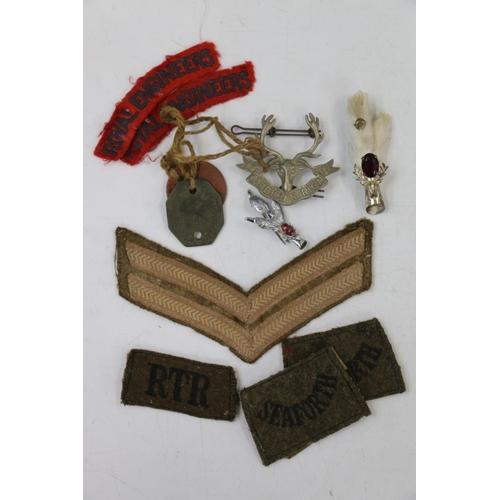 764 - Boer War Prisoner of War carved pipe, a grouse foot brooch, cap badges including Seaforth Highlander... 