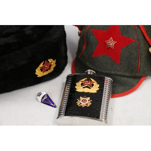 766 - Soviet Russian winter hat with enamelled badge, a replica green cloth peaked hat, a Soviet hip flask... 