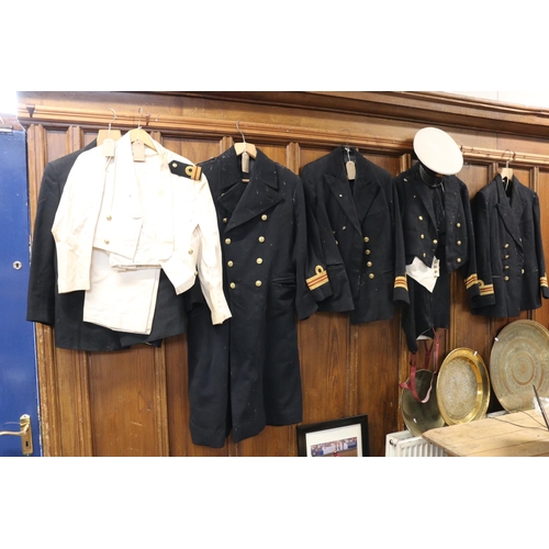 771 - Naval uniform including a black overcoat, jackets, ness dress and a peaked cap.