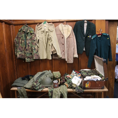 772 - Large collection of army uniform including camouflage smock jacket, waterproof, turtle shell helmet,... 