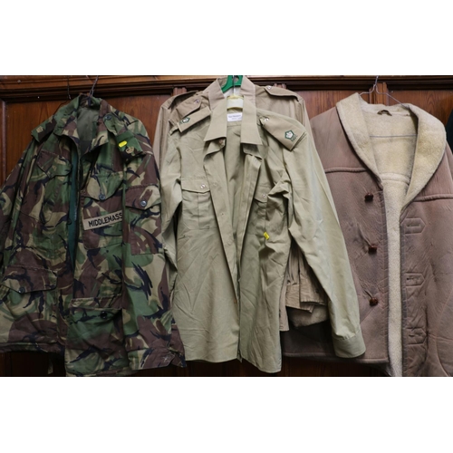 772 - Large collection of army uniform including camouflage smock jacket, waterproof, turtle shell helmet,... 