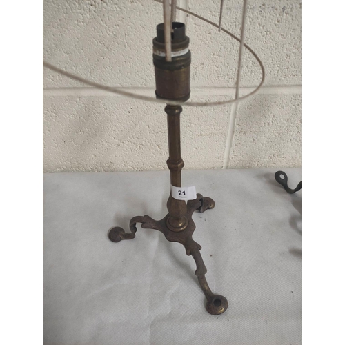 21 - Four antique brass table lamps on scroll supports.