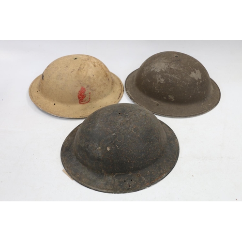 776 - Three Brodie type steel helmets. (3)