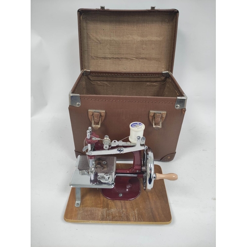 90 - Vintage child's sewing machine in case.