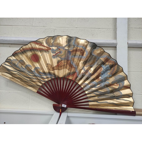 100 - Large Oriental bamboo fan of a four toed dragon chasing a flaming pearl.