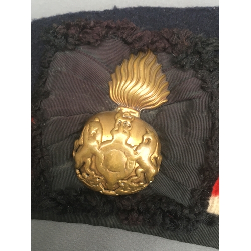 763A - WWII glengarry beret with brass fusiliers cap badge, the interior stamped with War Department markin... 