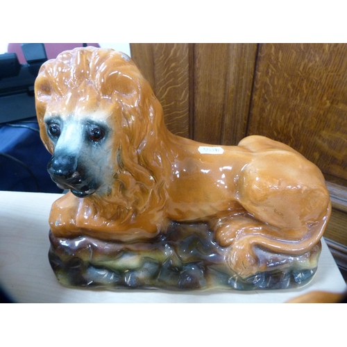 114 - Pair of Scottish Boness pottery recumbent lion figures with glass eyes.  (2)