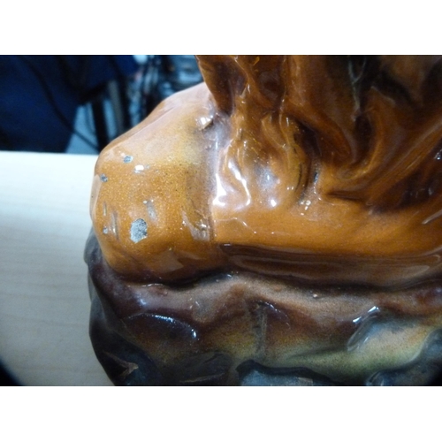 114 - Pair of Scottish Boness pottery recumbent lion figures with glass eyes.  (2)