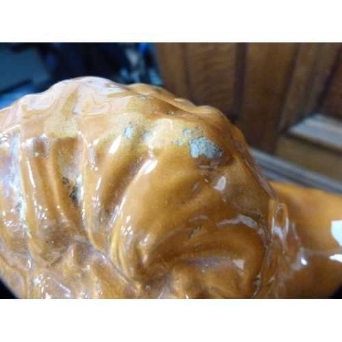 114 - Pair of Scottish Boness pottery recumbent lion figures with glass eyes.  (2)