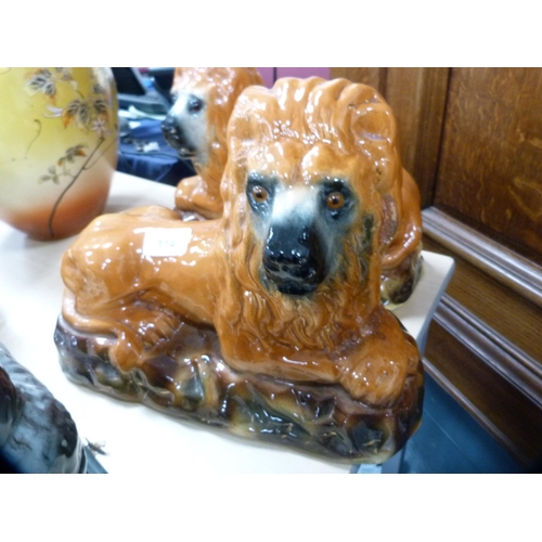 114 - Pair of Scottish Boness pottery recumbent lion figures with glass eyes.  (2)