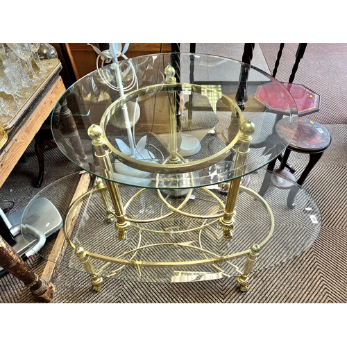 475 - Glass oval lounge table with brass stand 127 across,  with matching occasional table, 59 cm dia... 