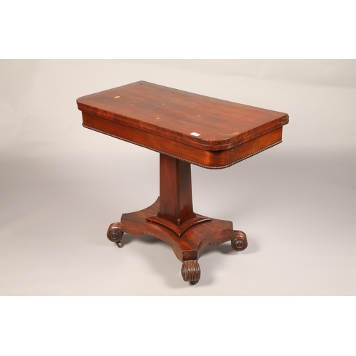 529 - Regency Mahogany games table on faceted pedestal on quarter form base raised with scroll feet