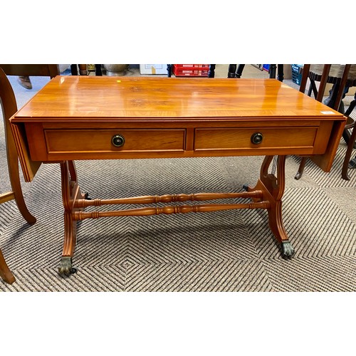 524 - Yew drop leaf lounge table with two drawers and paw feet on casters