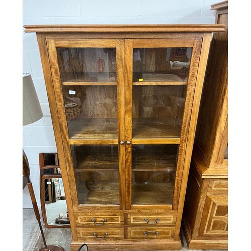 545 - Contemporary oak glazed book case over four drawers, 190 x 101 x 50 cm