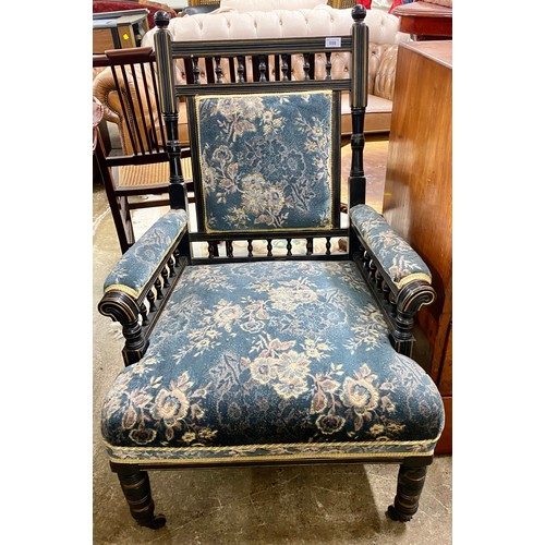 558 - Victorian ebonised parlour arm chair on casters