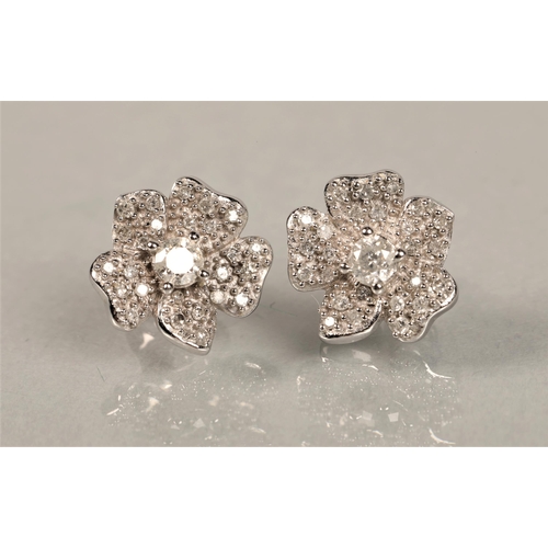 119 - Pair 9ct white gold diamond set flower stud earrings