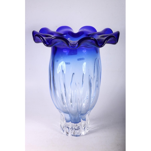 107 - Large clear to blue glass vase of floral form, 35cm.