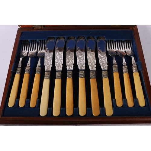 5 - Cased set of twelve fish knives and forks with engraved blades.