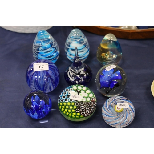 67 - Group of nine glass paperweights, 12cm.