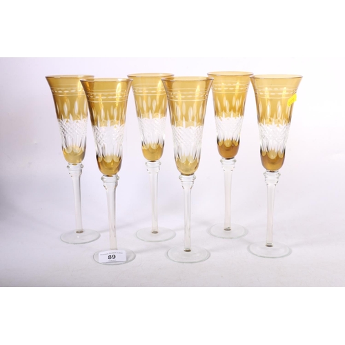 89 - Set of six clear and coloured glass champagne flutes, 25cm.