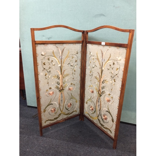 714 - 1930's two fold oak screen with embroidered panels, 107cm.