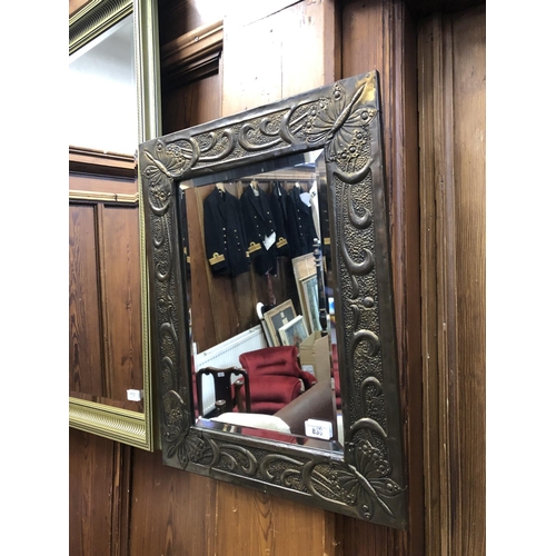 836 - Wall mirror with beaten brass frame and beveled glass, 57 x 44cm.