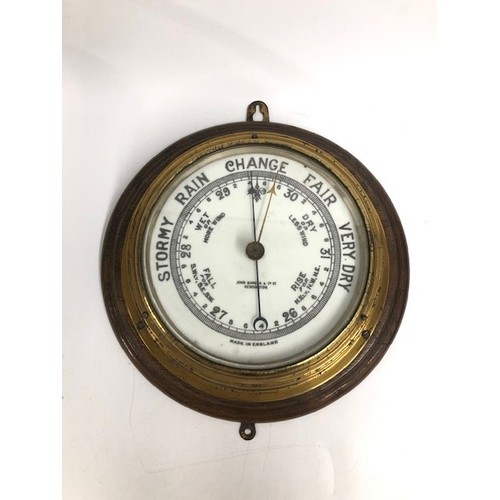 863 - Ships barometer, dial inscribed John Barker and Co ltd, Kensington, 26cm diameter.