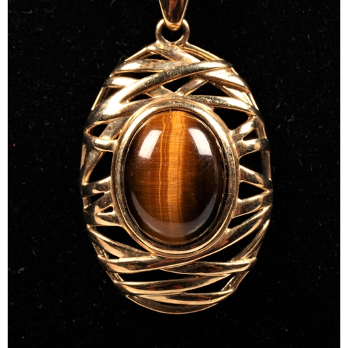 49 - Gold mounted tiger's eye pendant, 9ct. With an 18ct, 5g gold chain.