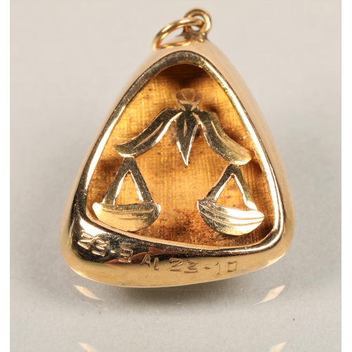 63 - Yellow metal locket on chain with a yellow metal pendant with balanced scales. 