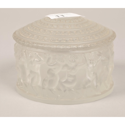 11 - Lalique glass jar with cover, with classical figures in relief, 11 cm diameter, 9 cm high with cover... 