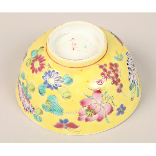 31 - Chinese yellow ground bowl with floral decoration and red work characters to base, 11.5 cm diameter