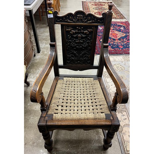 541 - Carved oak open armchair with carved figure panel back