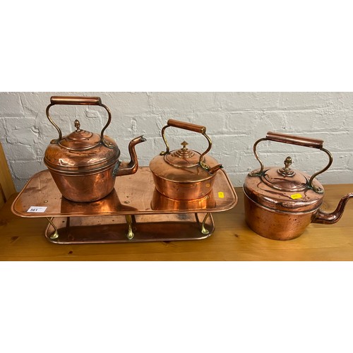 561 - Copper stand and three graduated copper kettles