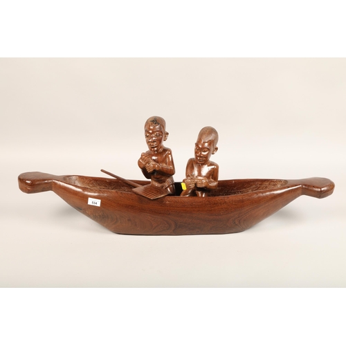 534 - Carved African boat with two figures