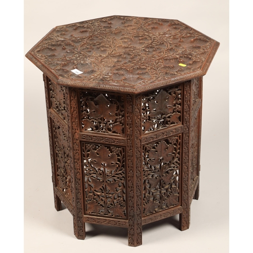 530 - Carved oak octagonal table decorated with grape vine62 cm high 60 cm wide