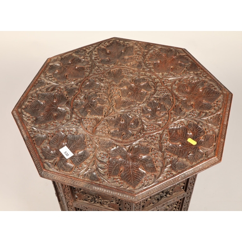 530 - Carved oak octagonal table decorated with grape vine62 cm high 60 cm wide