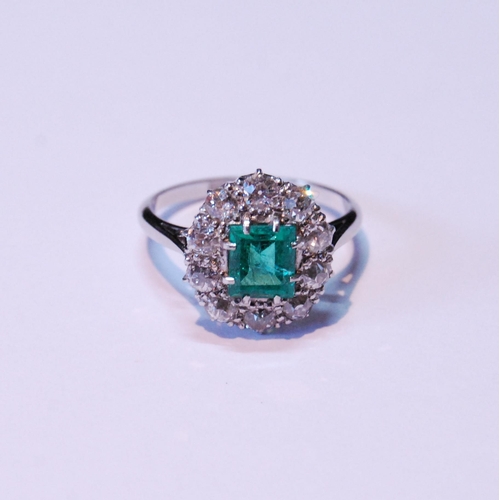 12 - Diamond and emerald oval cluster ring with rectangular emerald, approximately 5.5mm x 6mm, with ten ... 