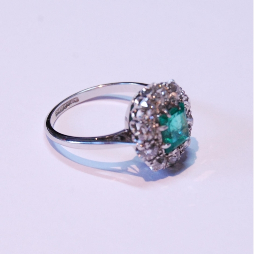 12 - Diamond and emerald oval cluster ring with rectangular emerald, approximately 5.5mm x 6mm, with ten ... 