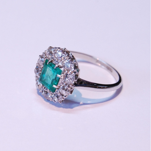 12 - Diamond and emerald oval cluster ring with rectangular emerald, approximately 5.5mm x 6mm, with ten ... 