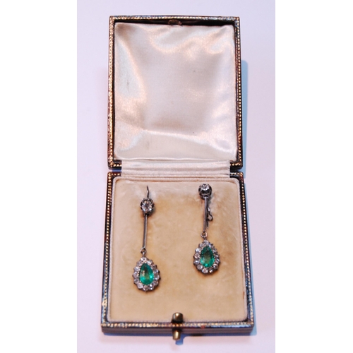 17 - Pair of Edwardian diamond and emerald drop earrings, each with a pear-shaped cluster dependant by a ... 