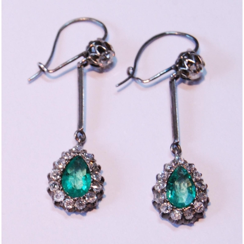 17 - Pair of Edwardian diamond and emerald drop earrings, each with a pear-shaped cluster dependant by a ... 
